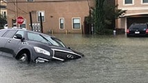 Car flooded on flooded street