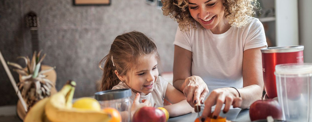 Mother and Daughter cutting fruit together
