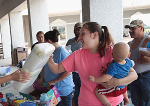 A mother receiving supplies at an emergency shelter