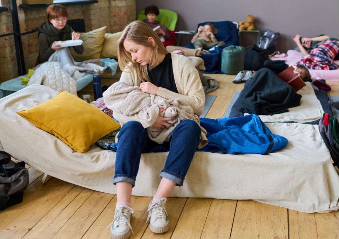 A mother breastfeeding at a shelter