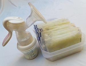 A breast pump and frozen packets of milk