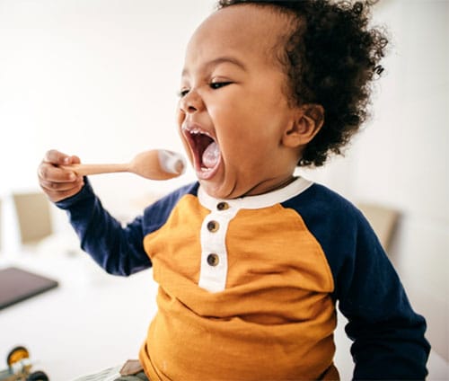 A child eating from a spoon