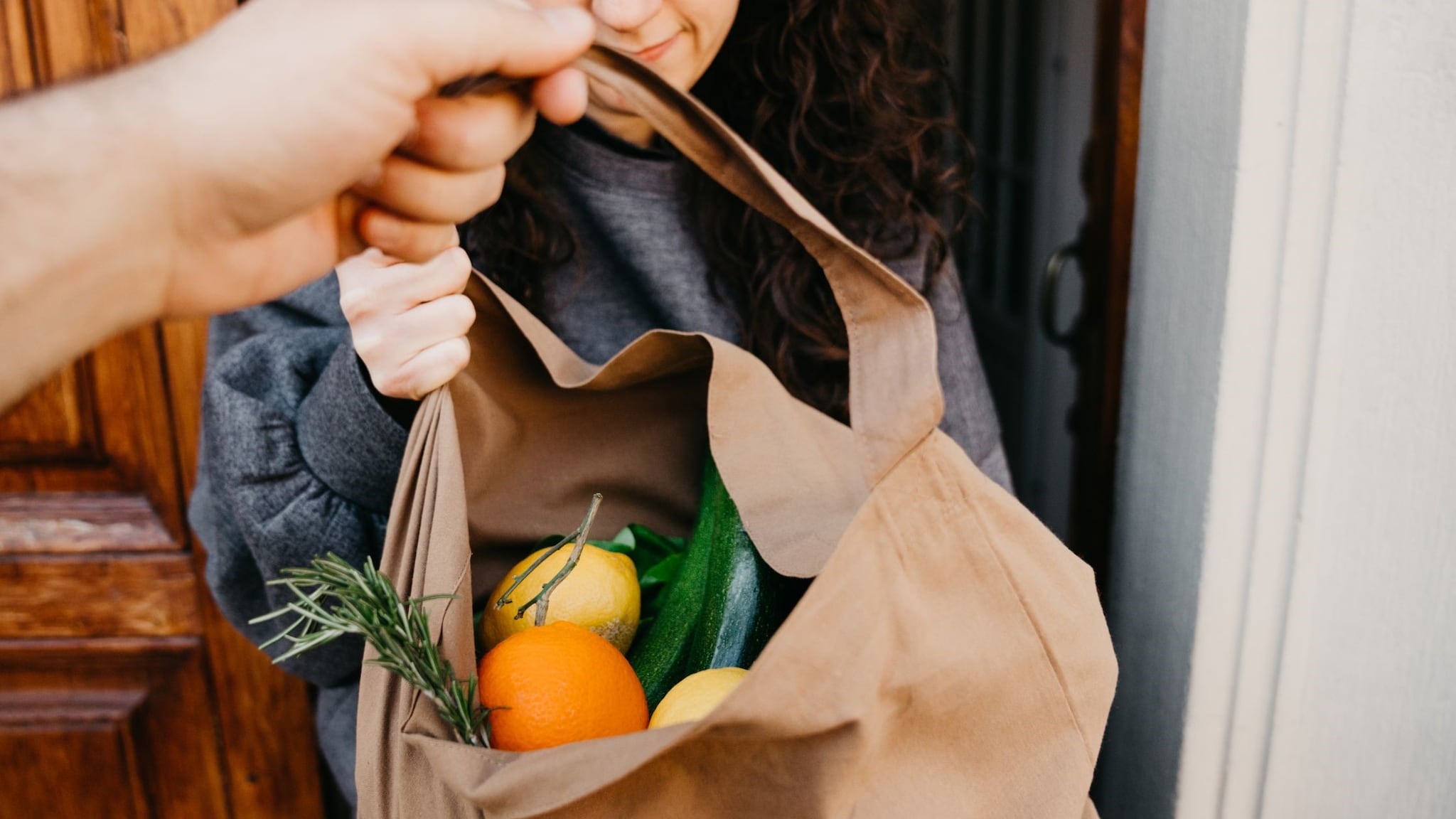 Delivering paper bag with fruits and vegetables.