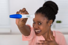 Smiling Woman Holding Pregnancy Test