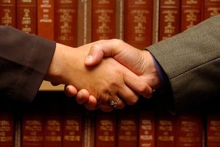 two individuals shaking hands