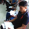 Local farmers receive training on how to use the mobile app.