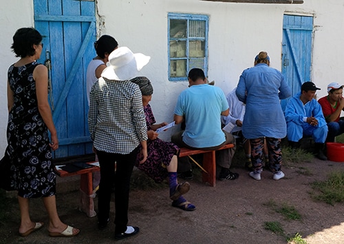 Residents randomly selected for participation in the serosurvey line up outside the local health department to get their blood drawn by a nurse from the Zhambyl regional health department.