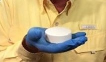Gloved hand holding tablet of fluoride