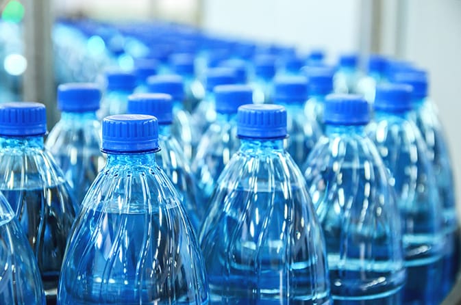 Closeup on mineral water bottles in raw and lines