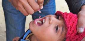 Photo shows a child receiving an immunization orally. CDC Global photo. 