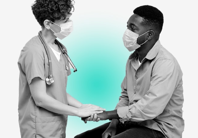 Patient and doctor talking.  Doctor is holding patient's hand demonstrating empathy.