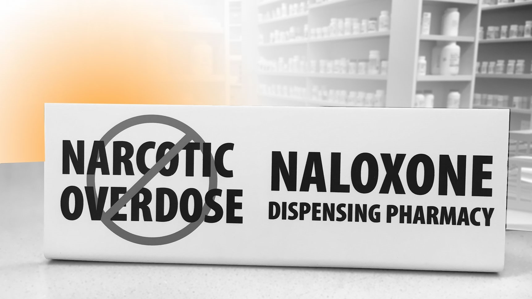 A pharmacy with a sign that says "Naloxone Dispensing Pharmacy"