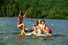 children swimming in lake
