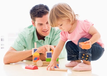 Dad and daughter playing with blocks