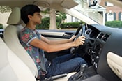 Teenage boy behind the wheel of a car