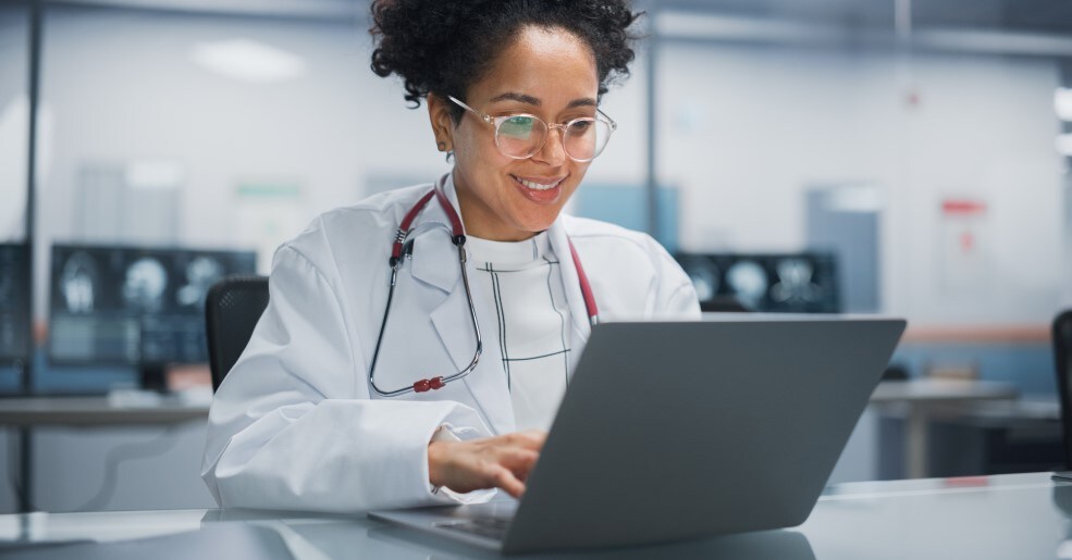 Female medical professional using a laptop computer