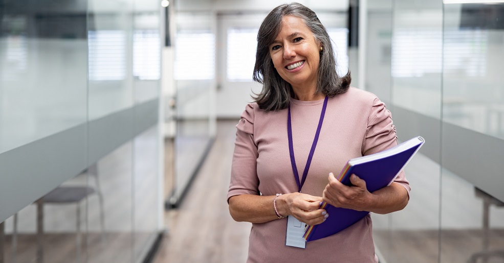 Portrait of a happy teacher smiling at the university