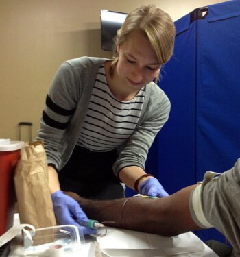 Lauren Linde preparing a patient for a blood test