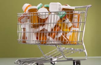 Photo: Shopping cart with prescription bottles inside.