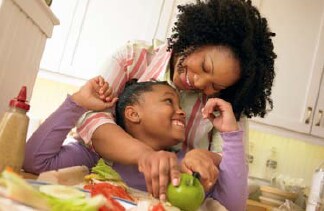 The photo shows a mother and daughter preparing a healthy meal in their kitchen.