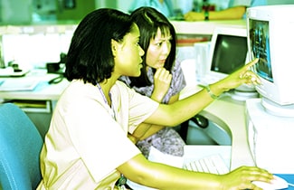 Photo: Medical professionals looking at a computer