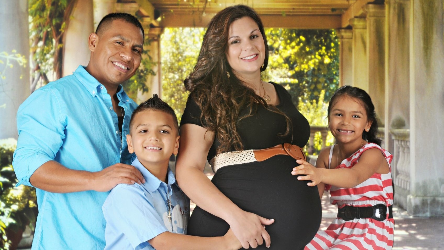 Family gathered around pregnant mother