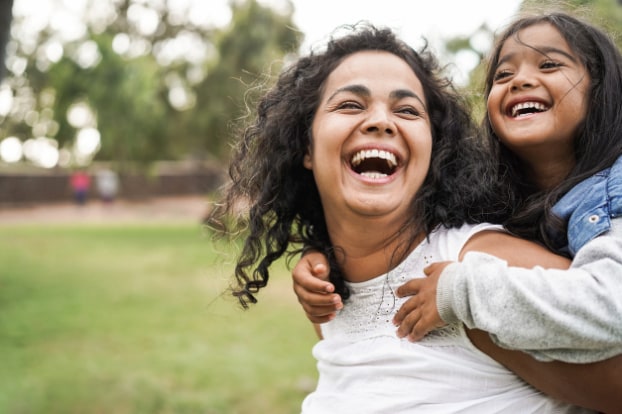 Mother and Daughter outside laughing together