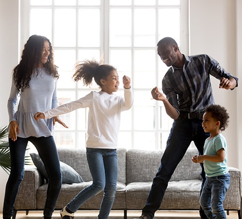 A family  dancing in the living room
