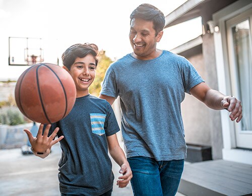 A father and son with a basketball
