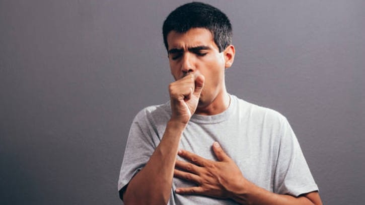 A man coughing