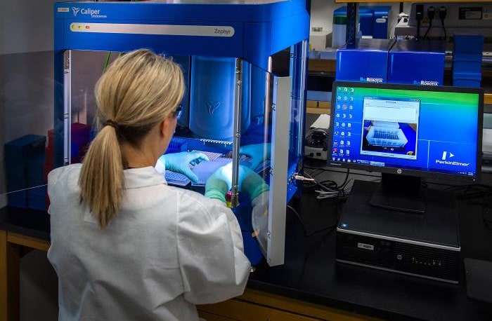 CDC scientist working with samples to be tested using a real-time PCR machine called a thermocycler to identify the various types of poliovirus.