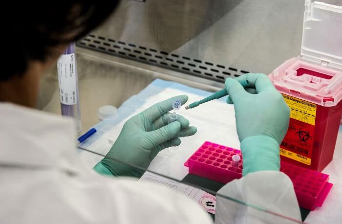 CDC scientist extracting viral RNA from samples of poliovirus genetic material for molecular testing. 