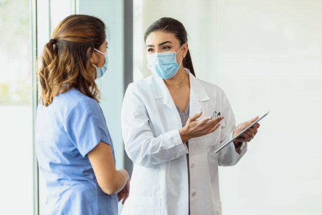 Female healthcare professionals discuss patient