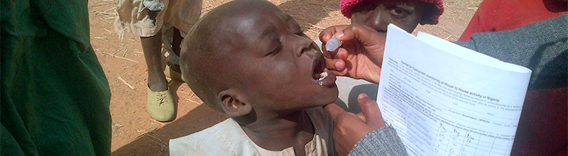 African boy taking oral vaccine