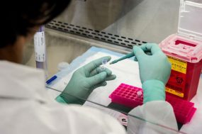 lab worker looking at vials