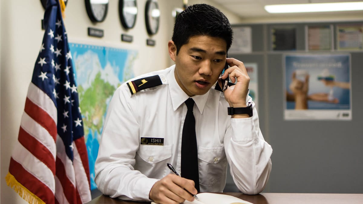 man in uniform making a phone call at an airport