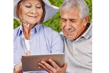 Older couple looking over a touchscreen