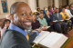 A Pastor smiling from the pulpit during a church service