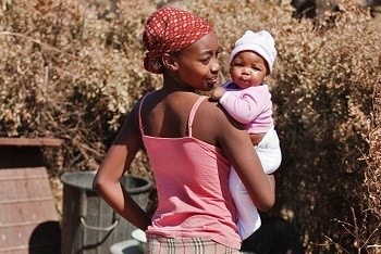 Young mother holding her child in her arms