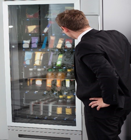 Employee searching for healthy vending machine choices