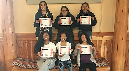 Group of young American Indian girls holding certifications.