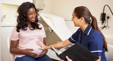 Photo of expectant mother talking to her nurse