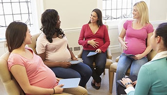 Group of pregnant women sitting and talking