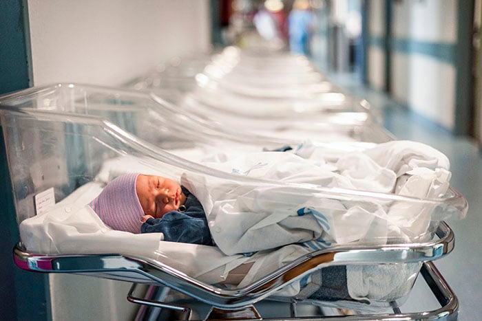 Newborn baby in a small hospital beds