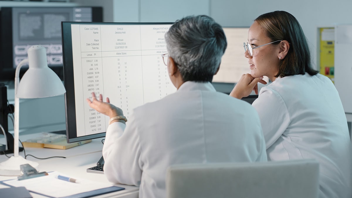 Doctors review patient information on a computer.
