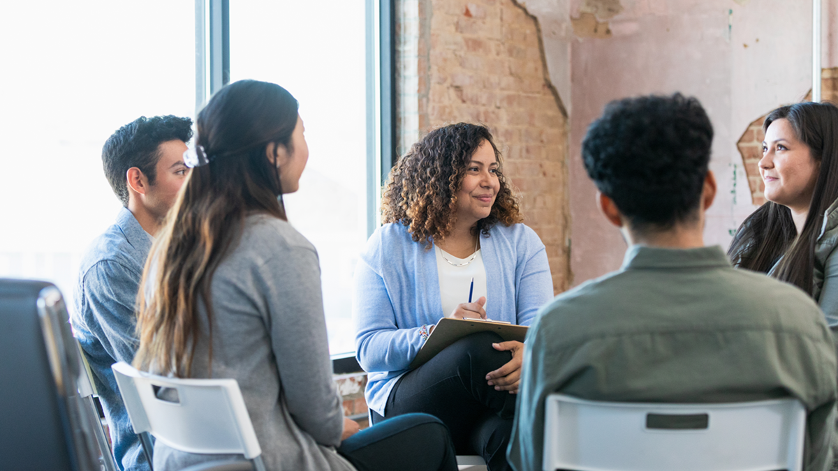 Five people sitting in a discussion group