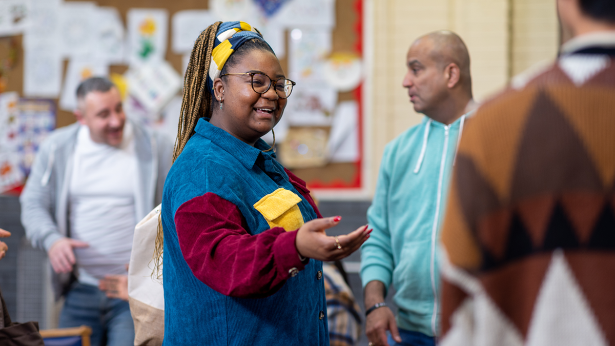 Woman speaking to others in classroom