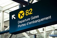 airport sign with arrow pointing to departure gate