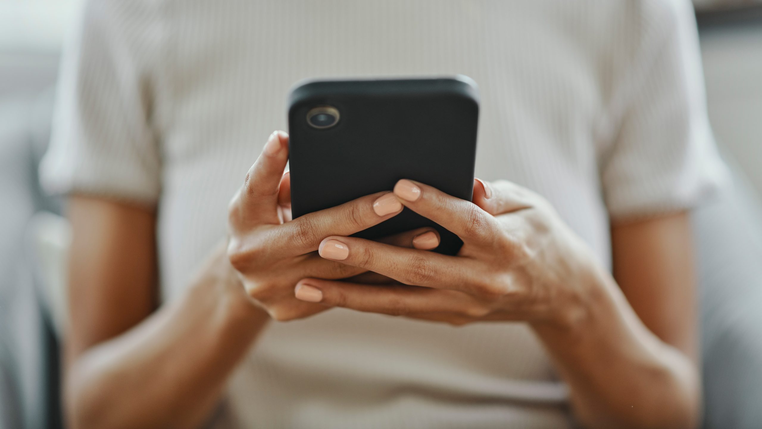 A woman holds a cell phone