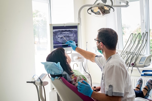 Dentist showing a patient x-rays.